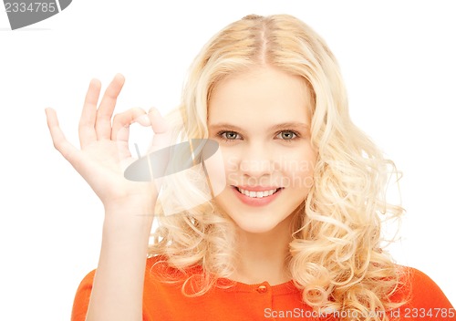 Image of lovely teenage girl showing ok sign