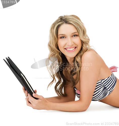 Image of woman in bikini with tablet pc computer