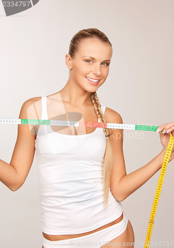 Image of young beautiful woman with measure tape