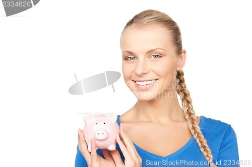 Image of lovely woman with piggy bank