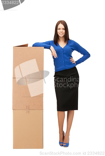 Image of attractive businesswoman with big boxes