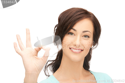 Image of young woman showing ok sign