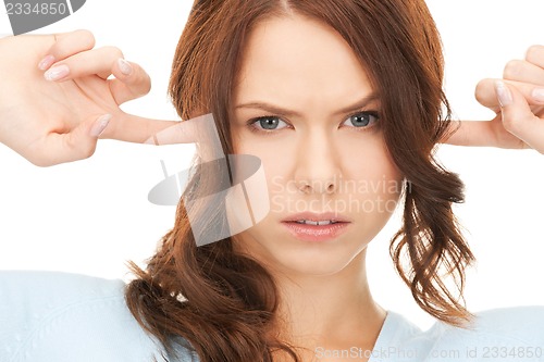 Image of woman with fingers in ears