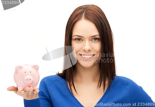 Image of lovely woman with piggy bank