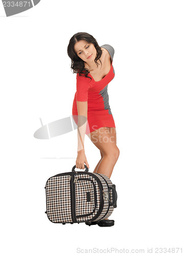Image of unhappy woman with heavy suitcase