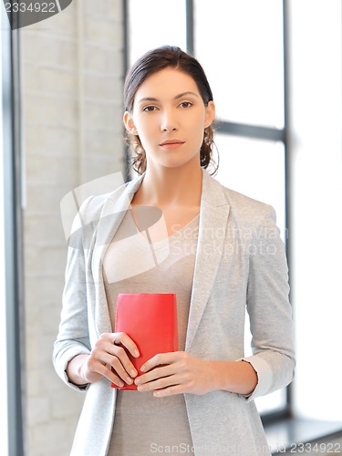 Image of calm and serious woman with book