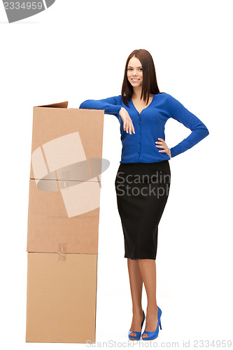 Image of attractive businesswoman with big boxes