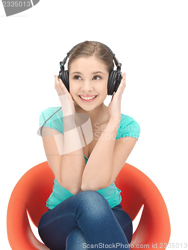 Image of happy teenage girl in big headphones