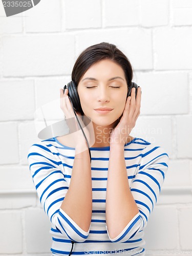 Image of happy teenage girl in big headphones