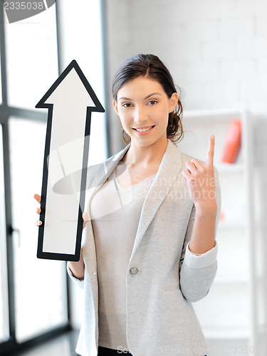 Image of businesswoman with direction arrow sign