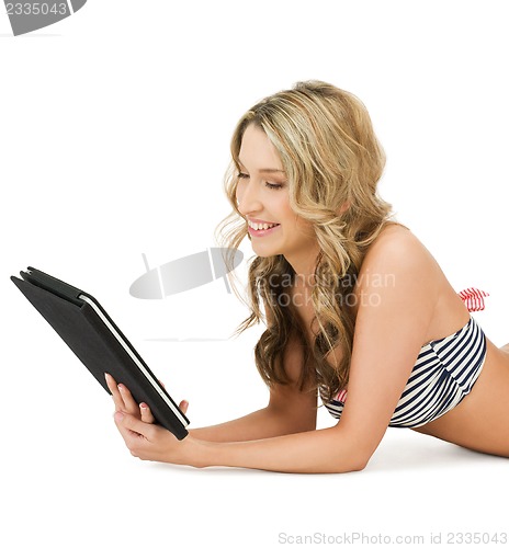 Image of woman in bikini with tablet pc computer