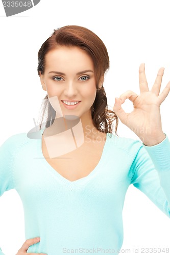 Image of lovely teenage girl showing ok sign