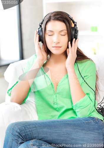 Image of happy teenage girl in big headphones