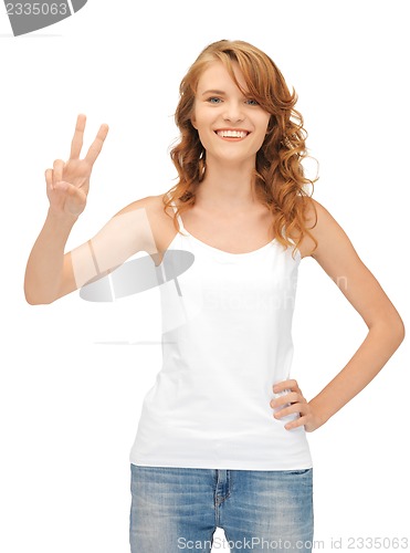 Image of girl in blank white t-shirt showing victory sign