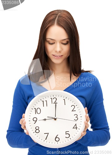 Image of woman holding big clock