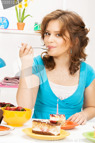 Image of lovely housewife with cake and candle