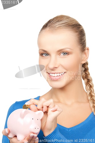 Image of lovely woman with piggy bank and money