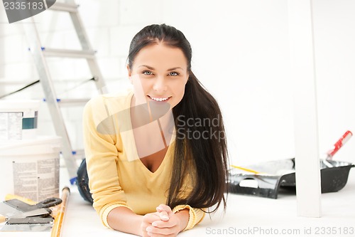 Image of lovely housewife making repairing works