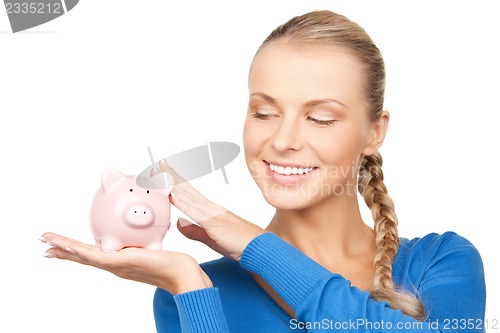 Image of lovely woman with piggy bank