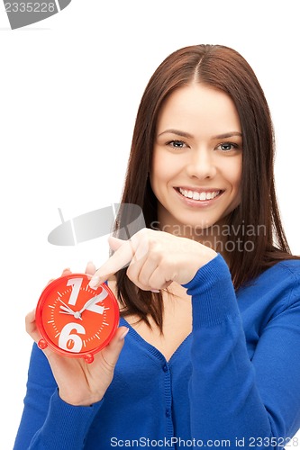 Image of woman holding alarm clock