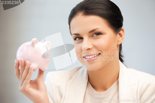 Image of lovely woman with piggy bank