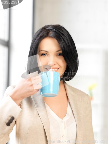 Image of lovely businesswoman with mug