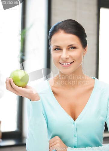 Image of lovely housewife with green apple