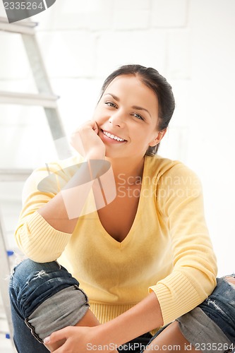 Image of lovely housewife making repairing works