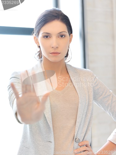 Image of young woman making stop gesture