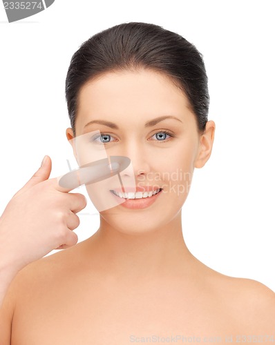 Image of beautiful woman pointing to nose