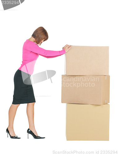 Image of attractive businesswoman with big boxes