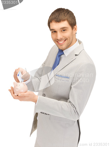 Image of man with piggy bank and money