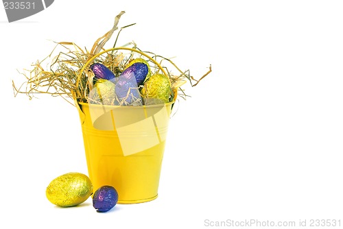 Image of yellow bucket with yellow and purple easter eggs