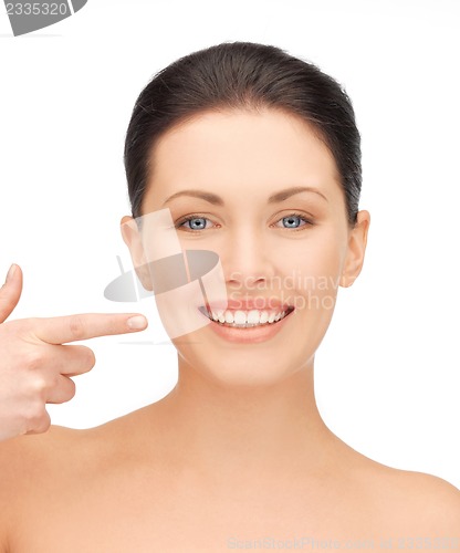 Image of beautiful woman pointing to teeth