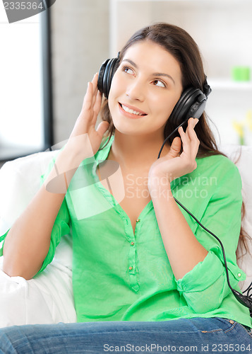 Image of happy teenage girl in big headphones