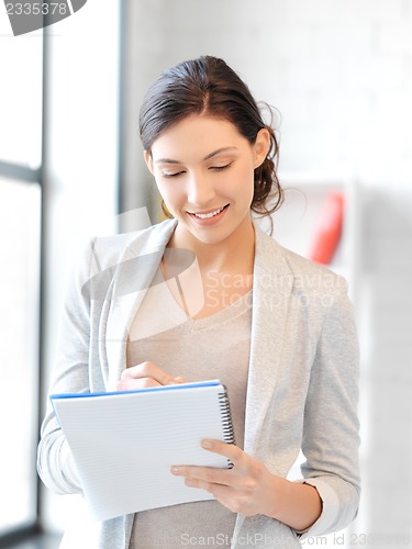 Image of happy woman with big notepad