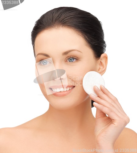 Image of beautiful woman with cotton pad