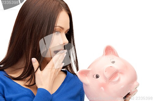 Image of lovely woman with piggy bank