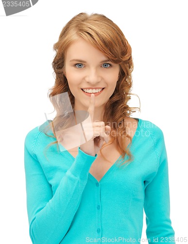 Image of teenage girl with finger on lips