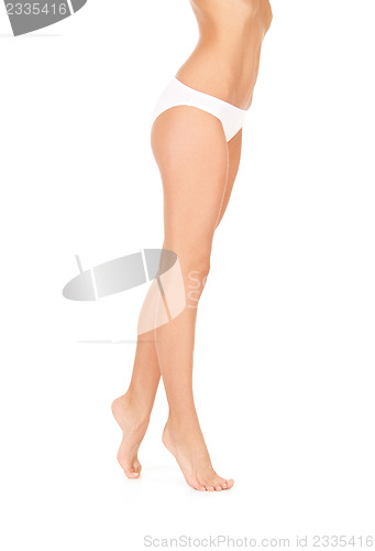 Image of female legs in white bikini panties