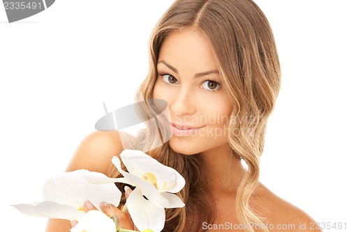 Image of beautiful woman with orchid flower