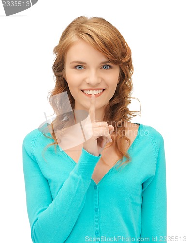 Image of teenage girl with finger on lips