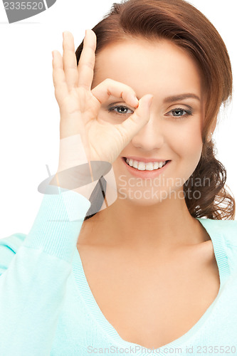 Image of lovely woman looking through hole from fingers