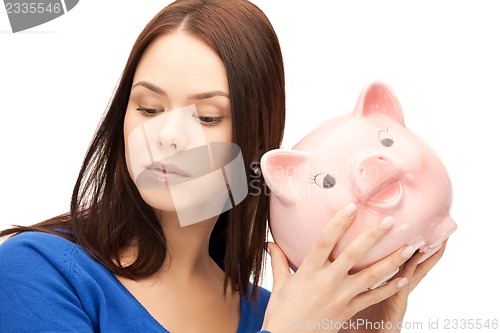 Image of lovely woman with piggy bank