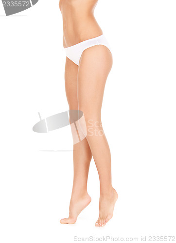 Image of female legs in white bikini panties