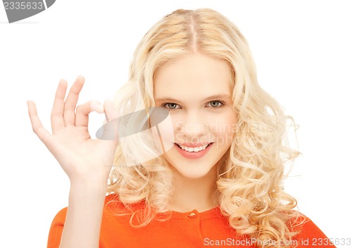 Image of lovely teenage girl showing ok sign