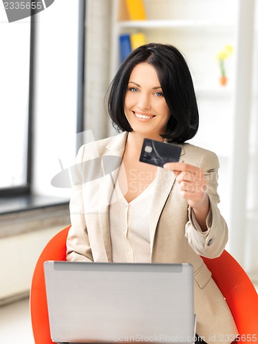 Image of happy woman with laptop computer and credit card