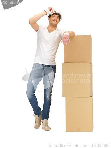 Image of handsome builder with big boxes