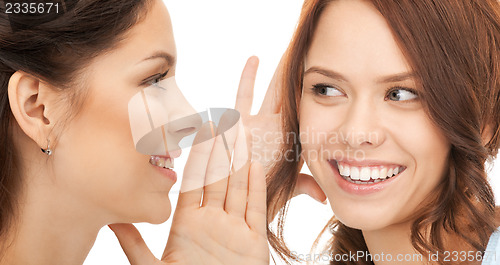 Image of two women spreading gossip