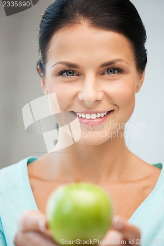 Image of lovely housewife with green apple
